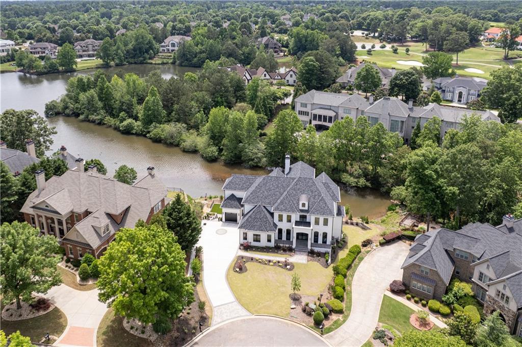 an aerial view of a house with outdoor space and lake view