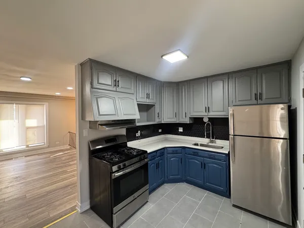 a kitchen with a refrigerator stove and sink