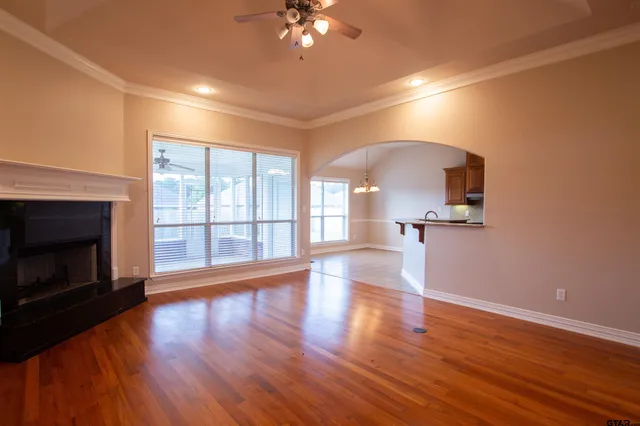 a view of a room with wooden floor and a fireplace