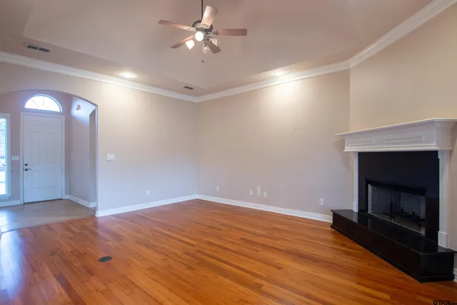 wooden floor in an empty room with a fireplace