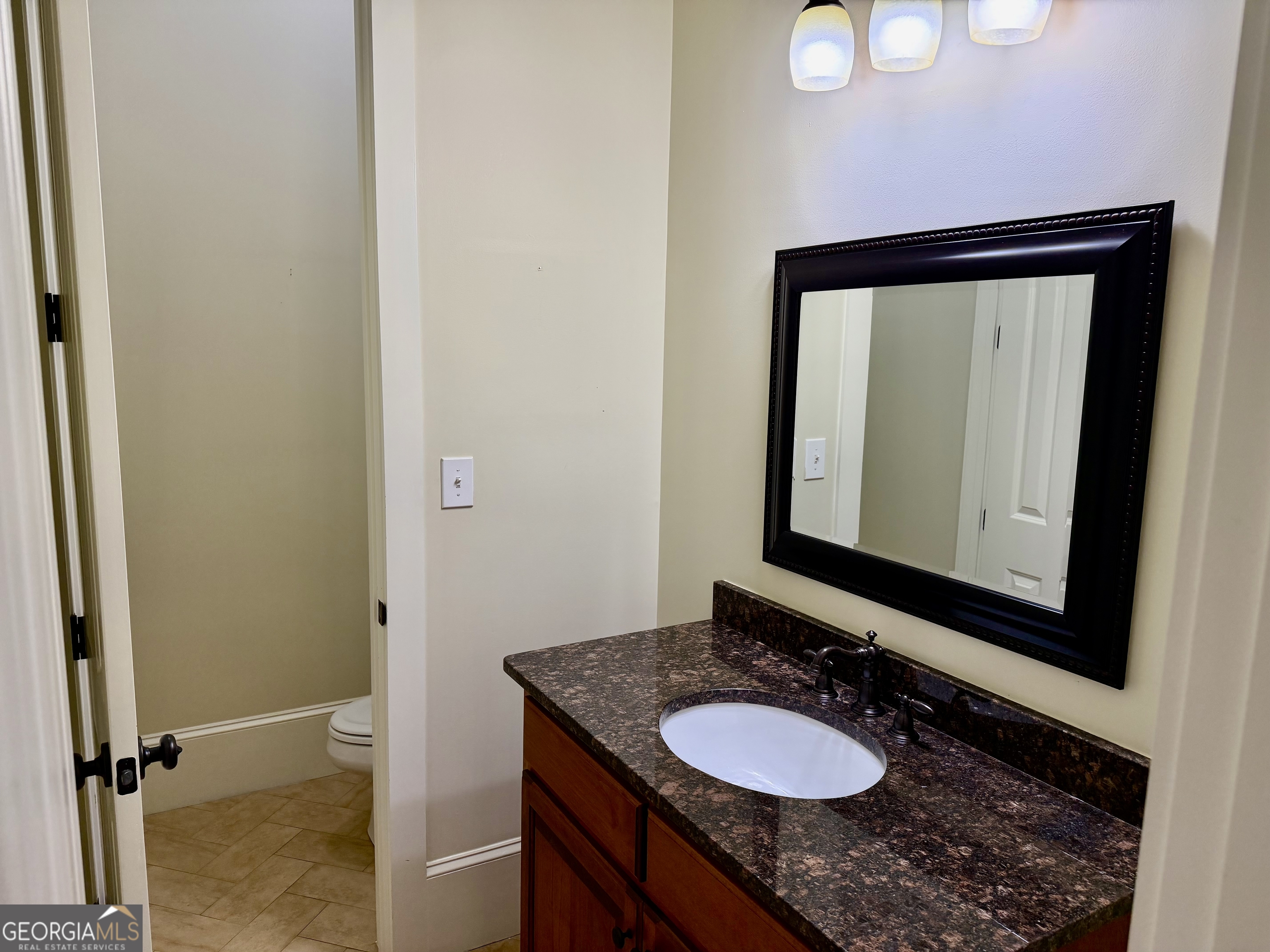 25 Charter Oak Drive Athens, GA 30607 - Photo 16 of 19 a bathroom with a granite countertop sink and a mirror