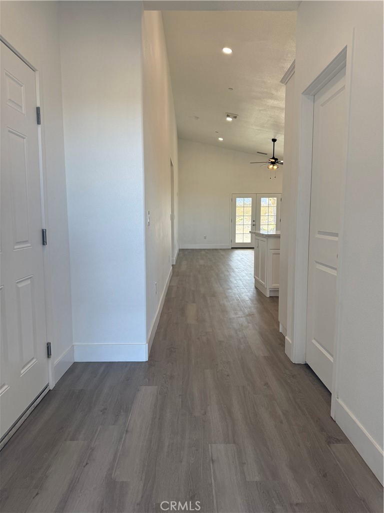 2115 Seville Place Pinon Hills, CA 92372 - Photo 14 of 31 wooden floor in an empty room with a window