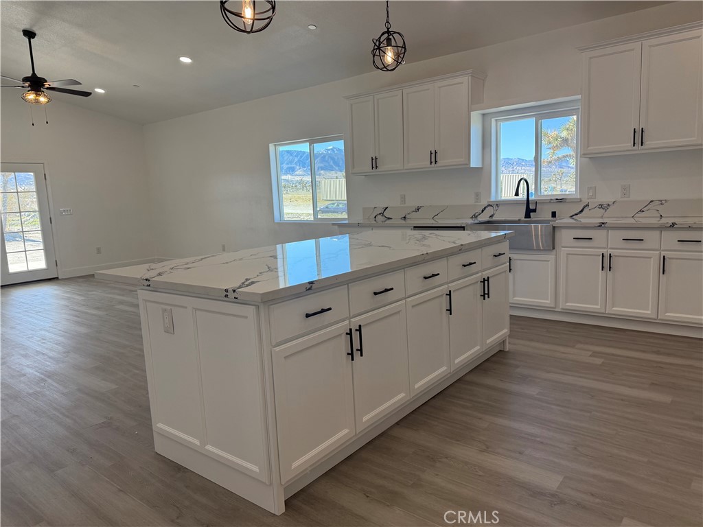 2115 Seville Place Pinon Hills, CA 92372 - Photo 15 of 31 a kitchen with granite countertop white cabinets and white appliances