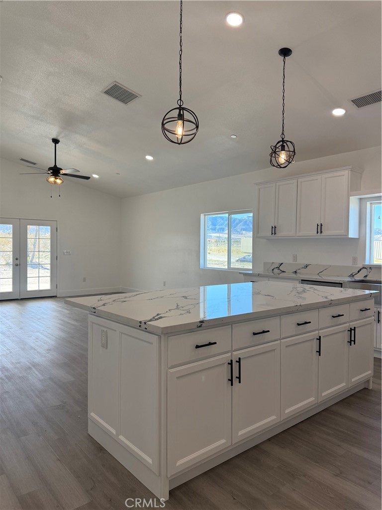 2115 Seville Place Pinon Hills, CA 92372 - Photo 16 of 31 a kitchen with a counter space cabinets and wooden floor