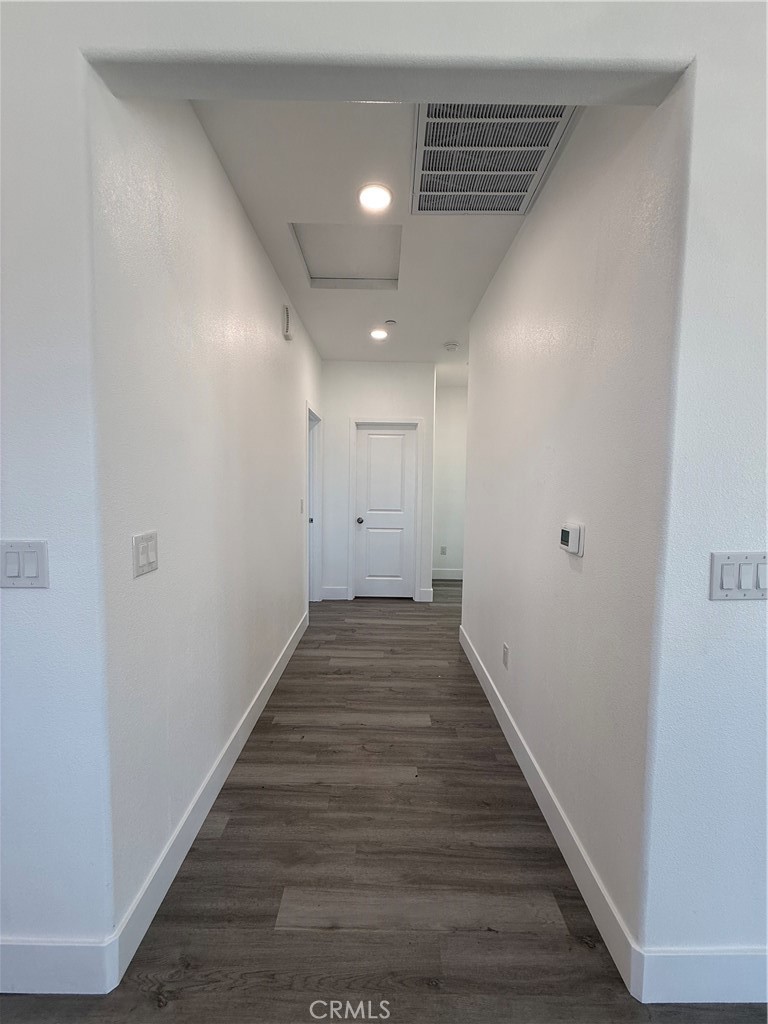 2115 Seville Place Pinon Hills, CA 92372 - Photo 22 of 31 a view of a hallway with wooden floor
