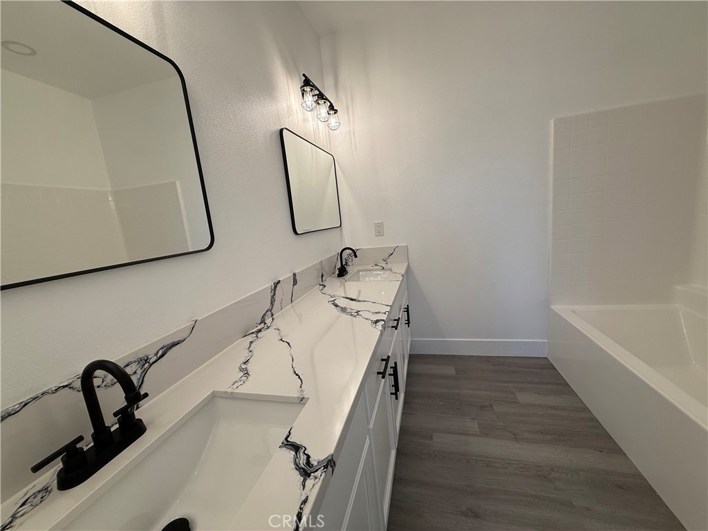 2115 Seville Place Pinon Hills, CA 92372 - Photo 30 of 31 a bathroom with a sink and mirror