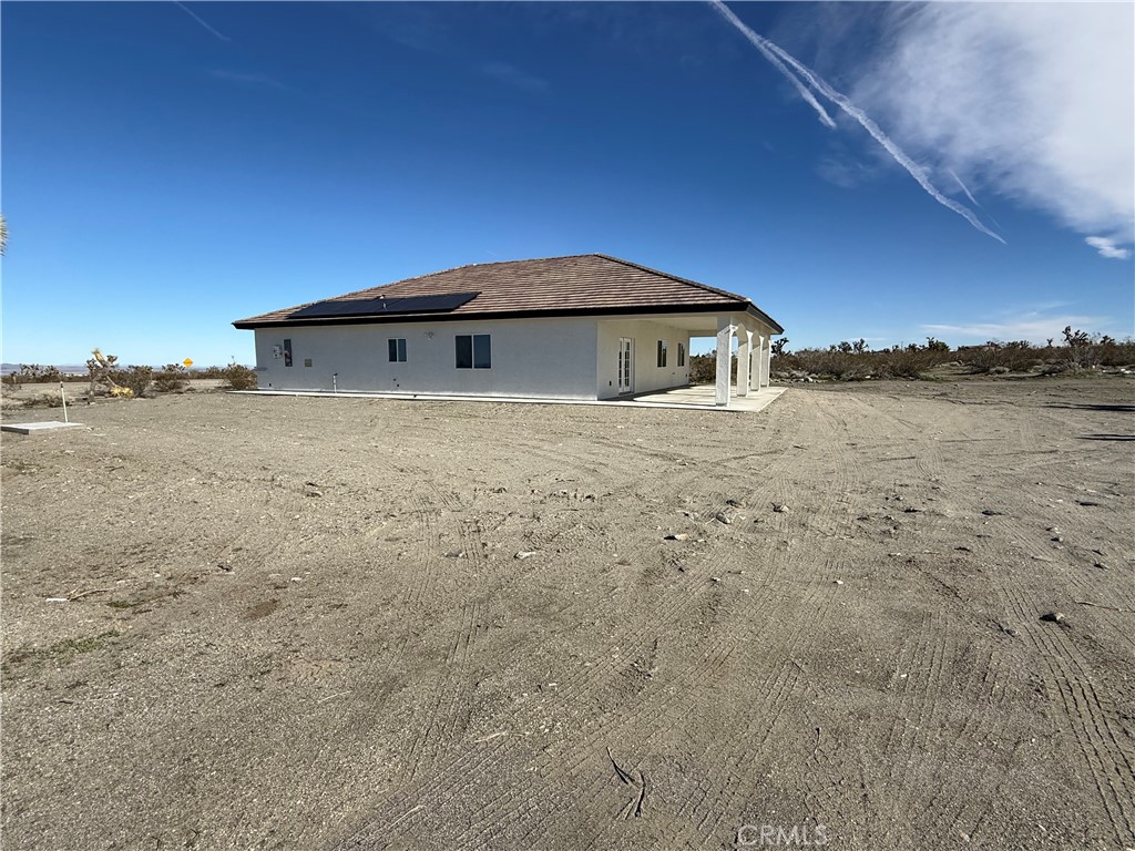 2115 Seville Place Pinon Hills, CA 92372 - Photo 5 of 31 a view of a house with a yard