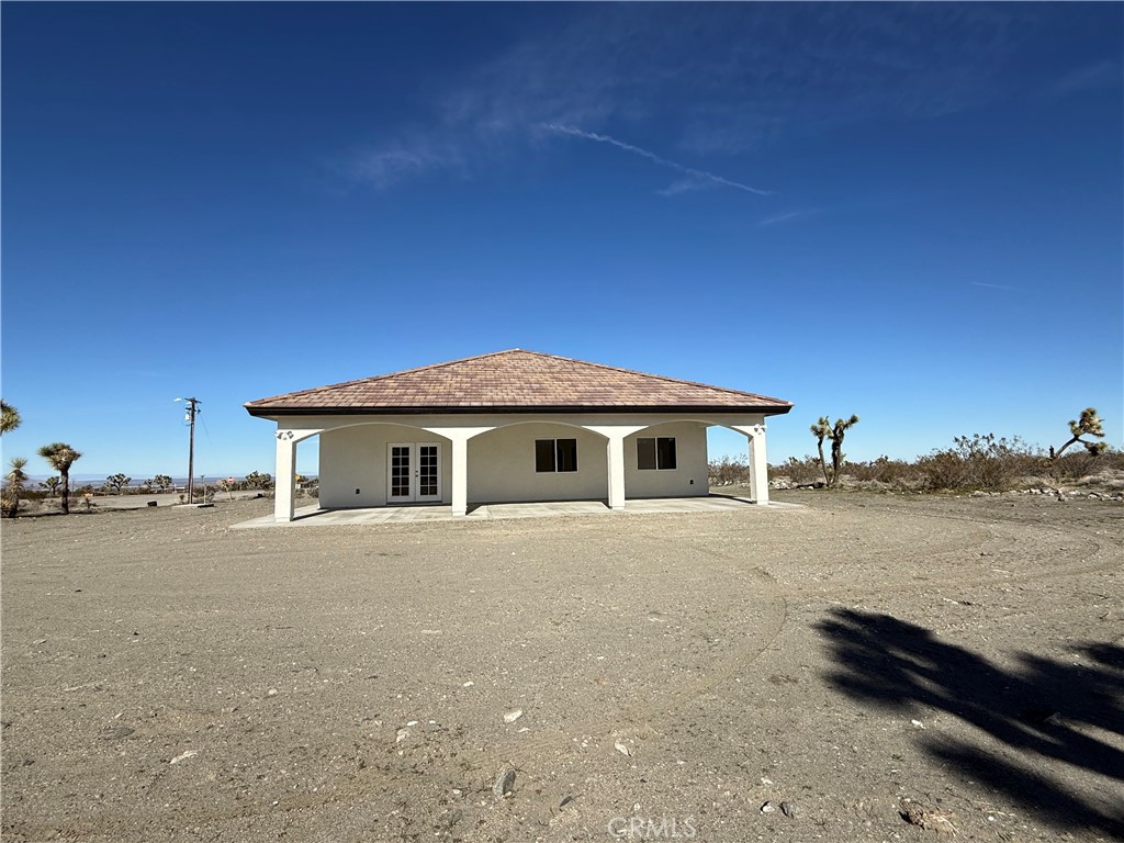 2115 Seville Place Pinon Hills, CA 92372 - Photo 7 of 31 a view of a house with a yard next to a road