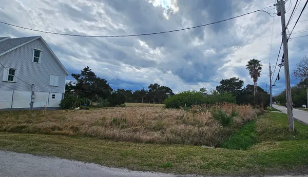 a view of a road with a building in the background