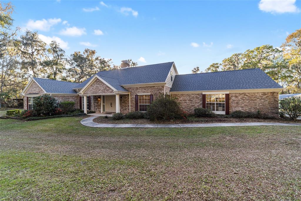 9080 Southwest 19th Avenue Road Ocala, FL 34476 - Photo 2 of 100 a front view of a house with garden