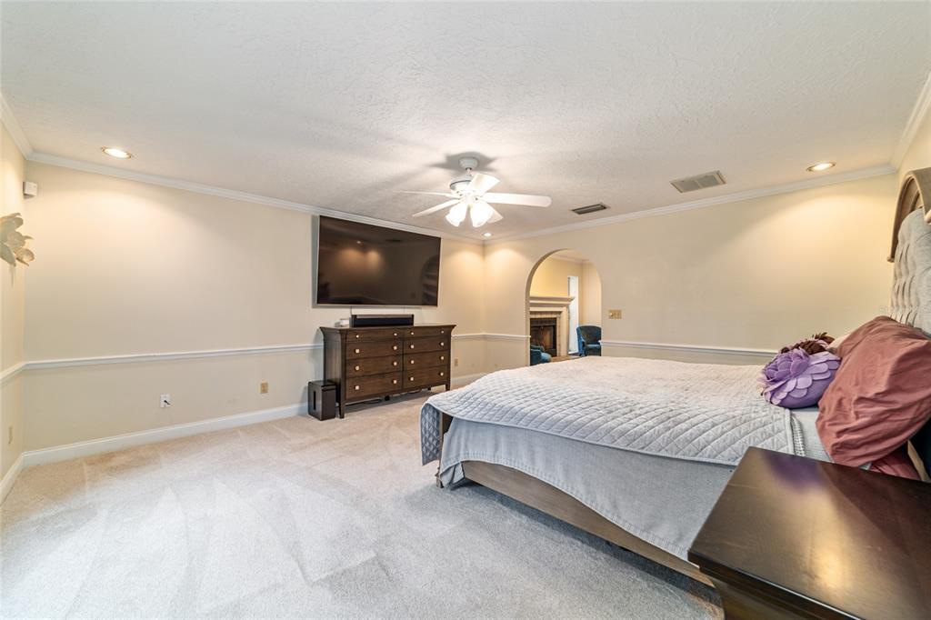9080 Southwest 19th Avenue Road Ocala, FL 34476 - Photo 49 of 100 a spacious bedroom with a bed and a flat screen tv