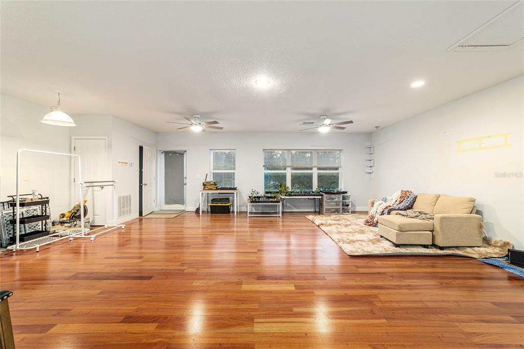 9080 Southwest 19th Avenue Road Ocala, FL 34476 - Photo 60 of 100 a living room with furniture and kitchen view with wooden floor