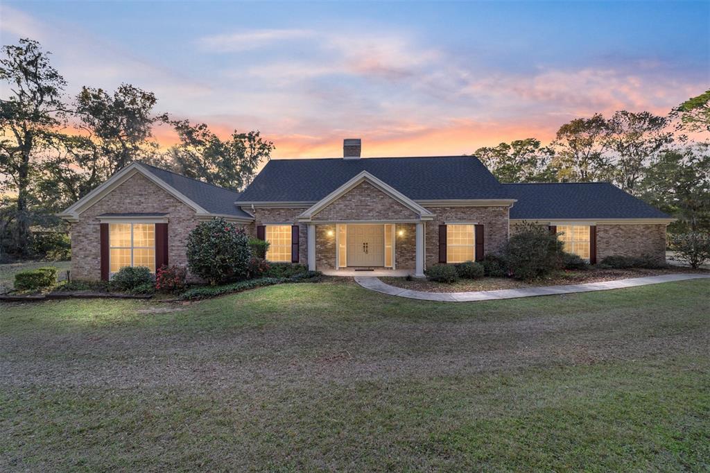 9080 Southwest 19th Avenue Road Ocala, FL 34476 - Photo 6 of 100 a front view of a house with a yard and trees