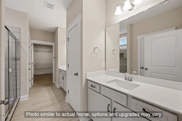 a bathroom with a glass shower door