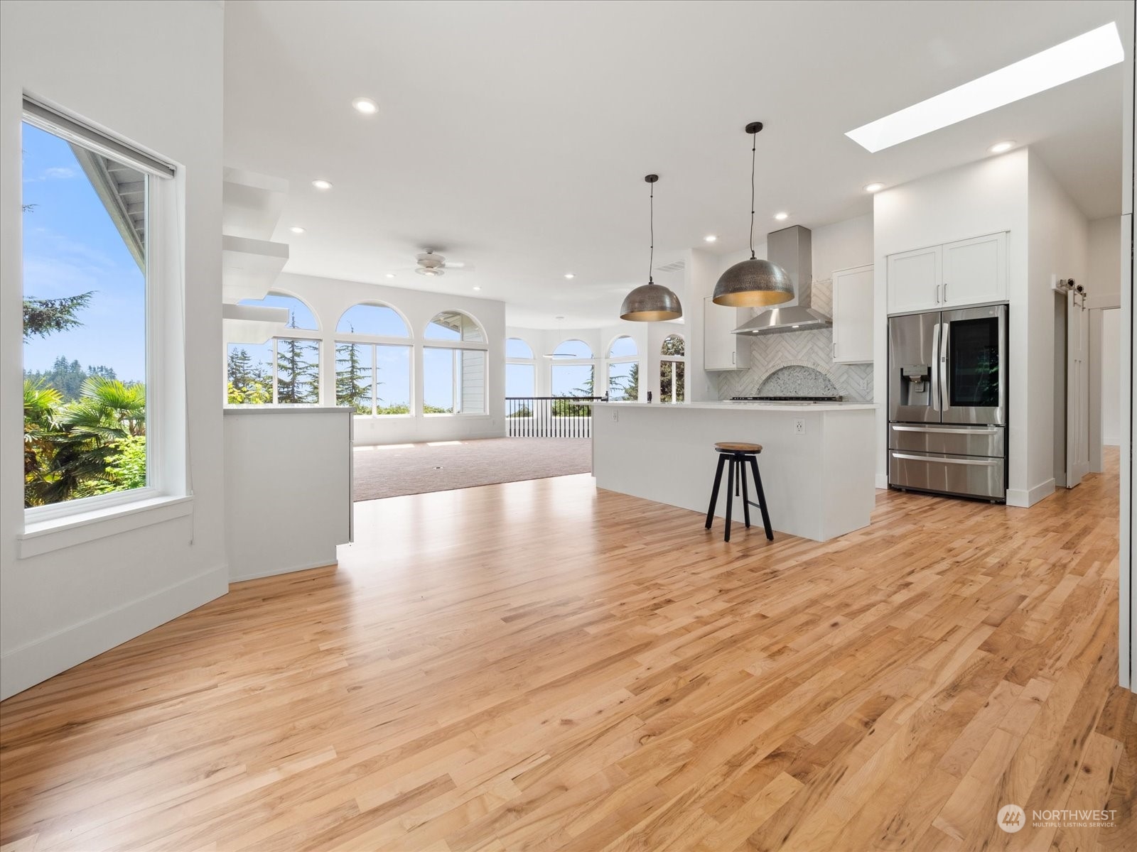 4191 Islander Way Anacortes, WA 98221 - Photo 22 of 40 a large kitchen with cabinets wooden floor and stainless steel appliances