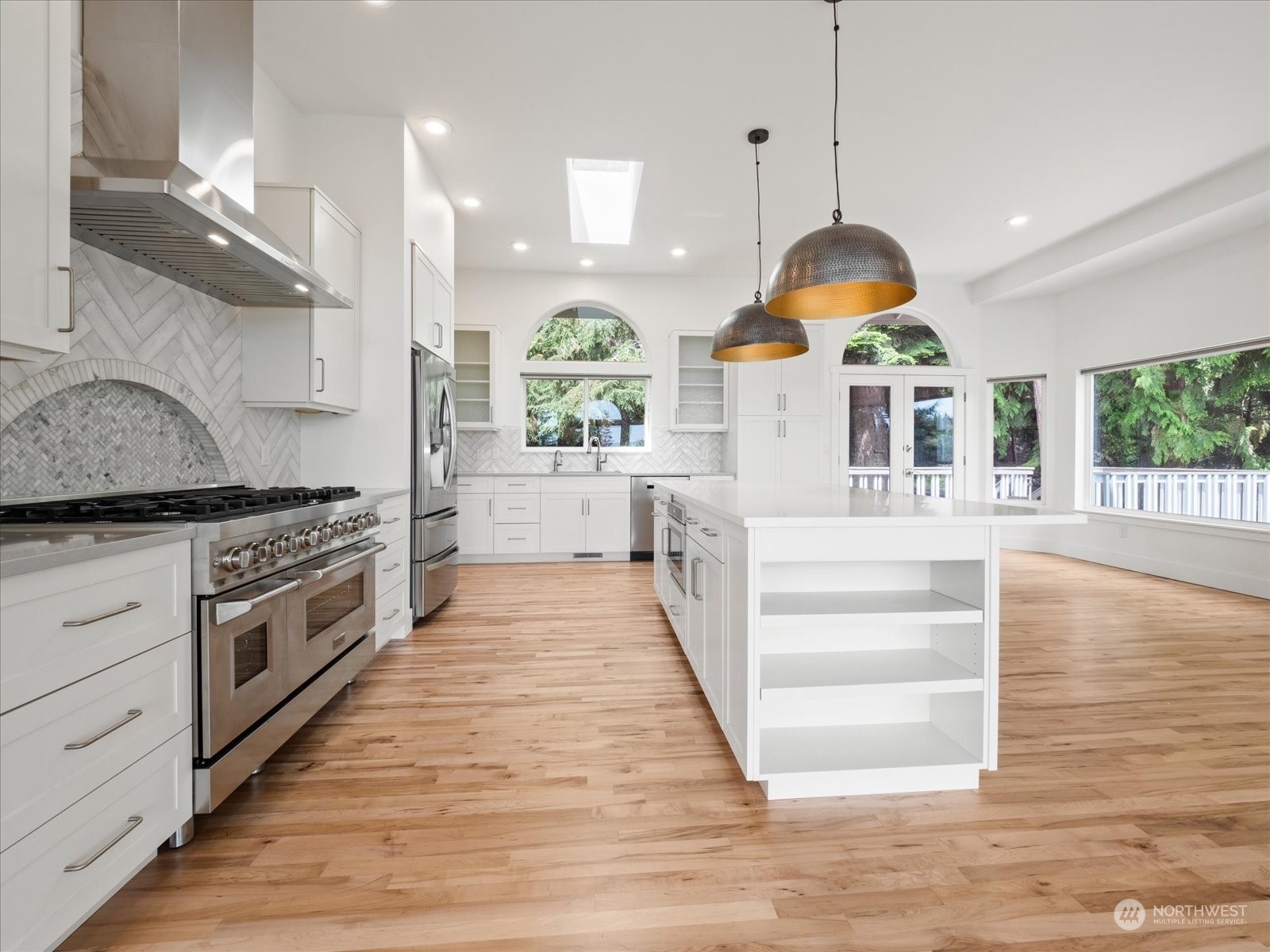 4191 Islander Way Anacortes, WA 98221 - Photo 5 of 40 a kitchen with stainless steel appliances kitchen island a large island in the center and a large window