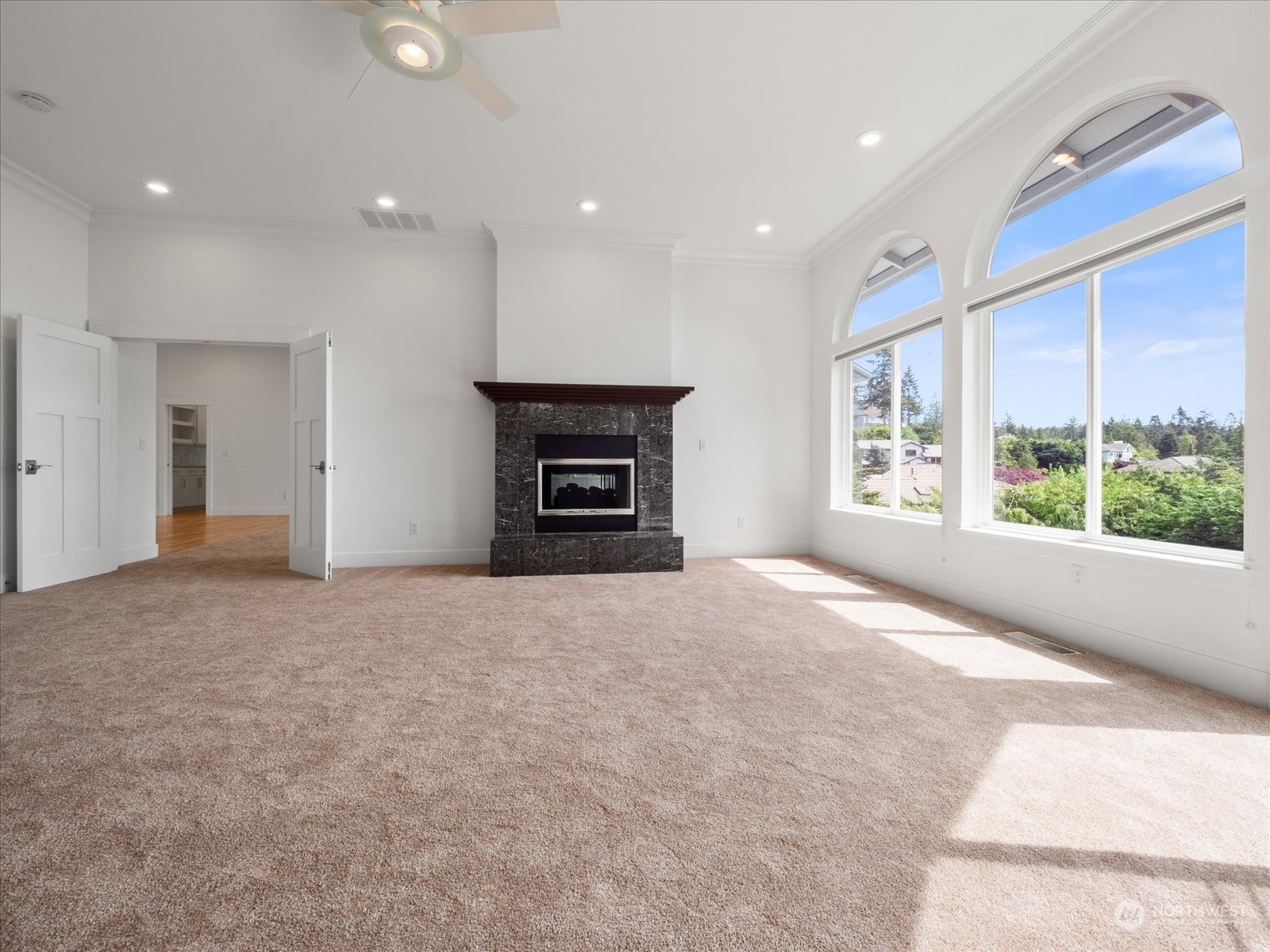 4191 Islander Way Anacortes, WA 98221 - Photo 7 of 40 a view of empty room with a fireplace and windows