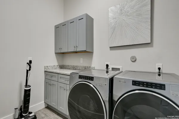a utility room with sink dryer and washer