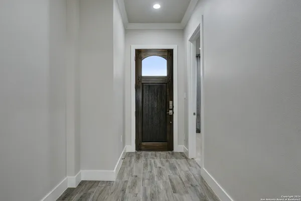 a view of a room with wooden floor