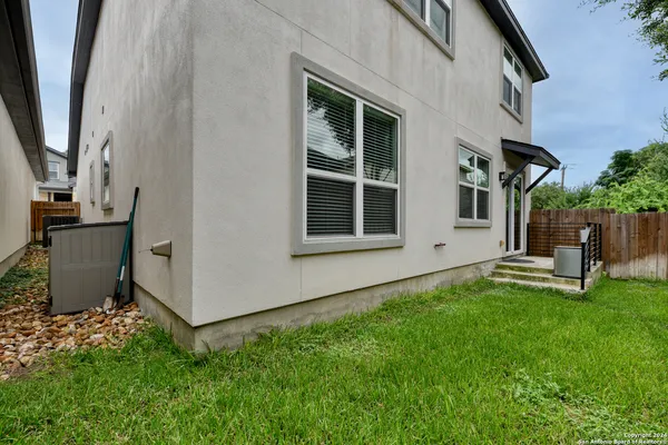a view of a house with backyard and sitting area