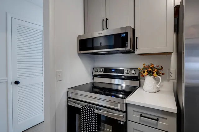 a kitchen with stainless steel appliances a stove and a microwave