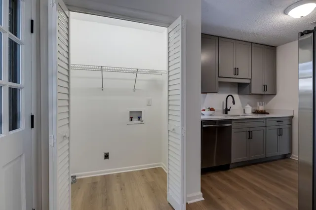 a kitchen with granite countertop a refrigerator and a sink