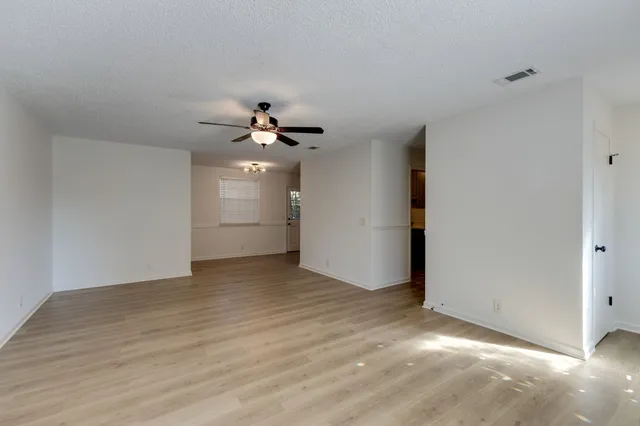 a view of an empty room with a ceiling fan