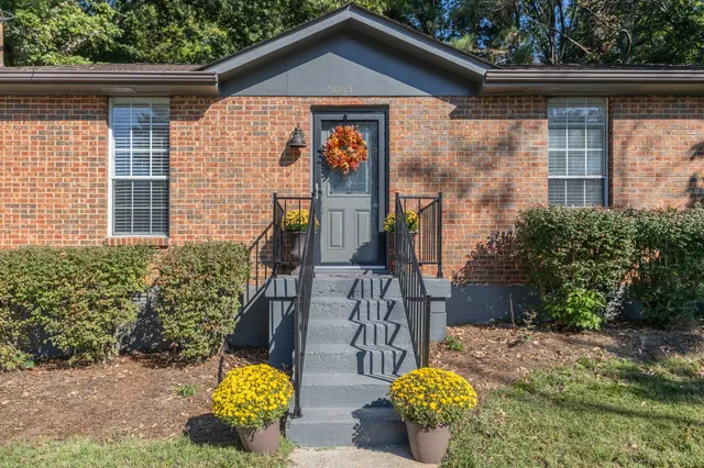 a front view of a house with outdoor seating