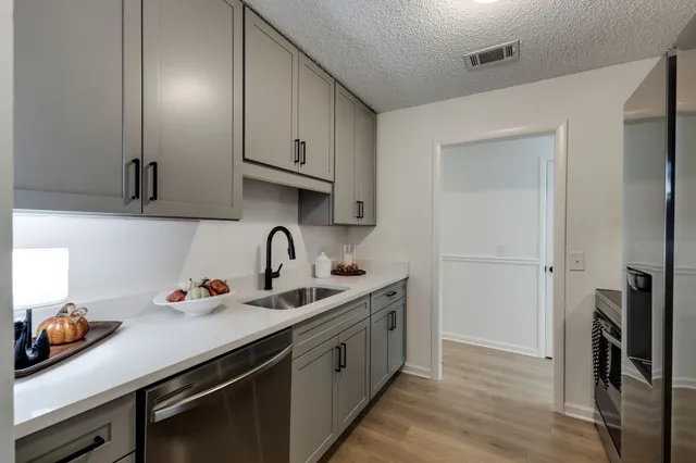 a kitchen with stainless steel appliances a sink stove and refrigerator