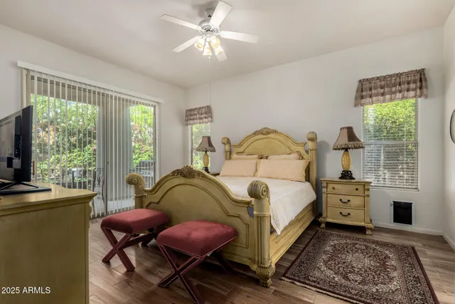 a bedroom with a bed a table and chair