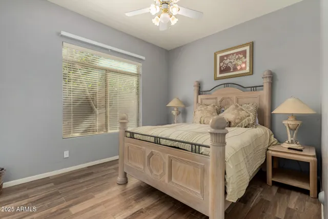 a spacious bedroom with a bed and a chandelier