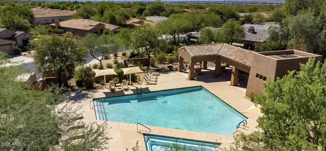 an aerial view of a house with a yard basket ball court and outdoor seating