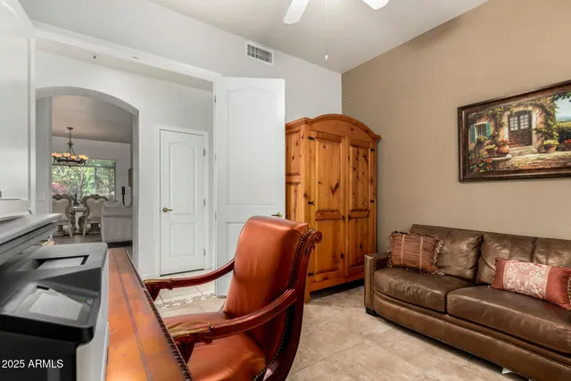 a living room with furniture a couch and potted plant
