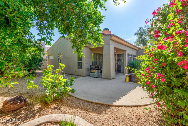 a view of a house with a yard and garden