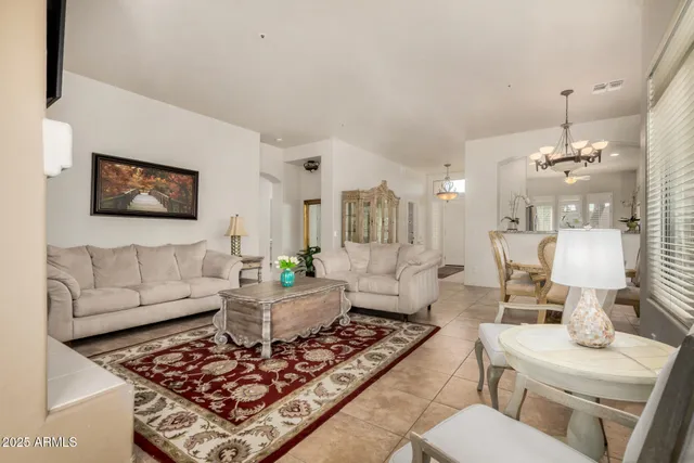 a living room with furniture and a chandelier