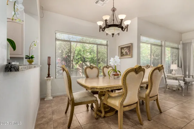 a dining room with furniture a chandelier and window