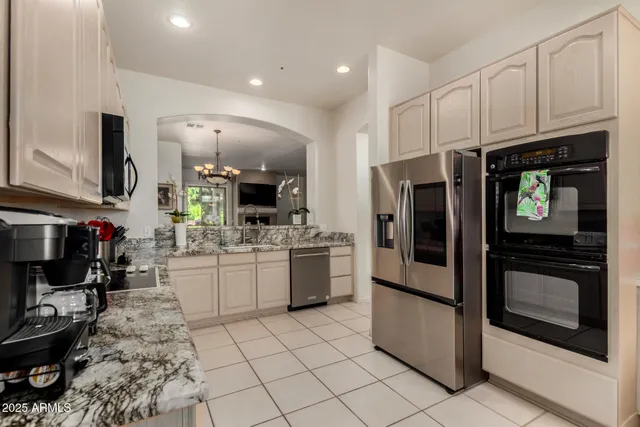 a kitchen with a sink cabinets and stainless steel appliances
