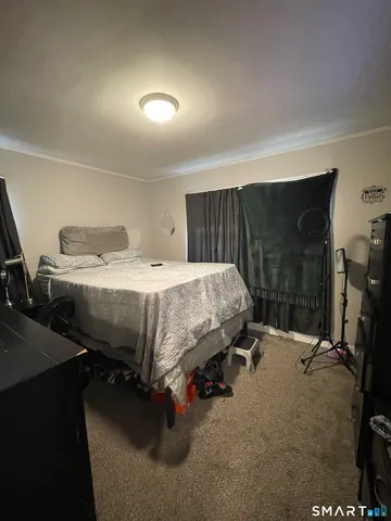 a bed sitting in a bedroom and table
