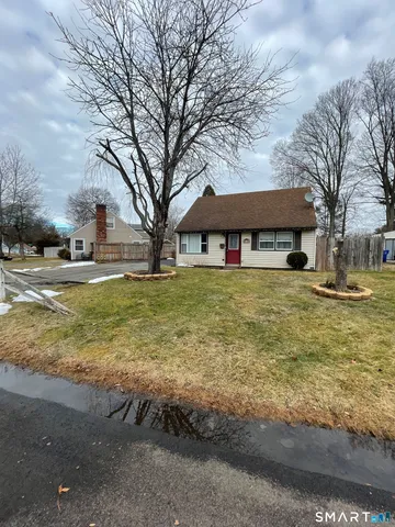 a view of a large white house with a large pool
