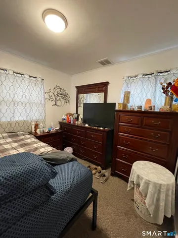 a bedroom with a bed and dresser
