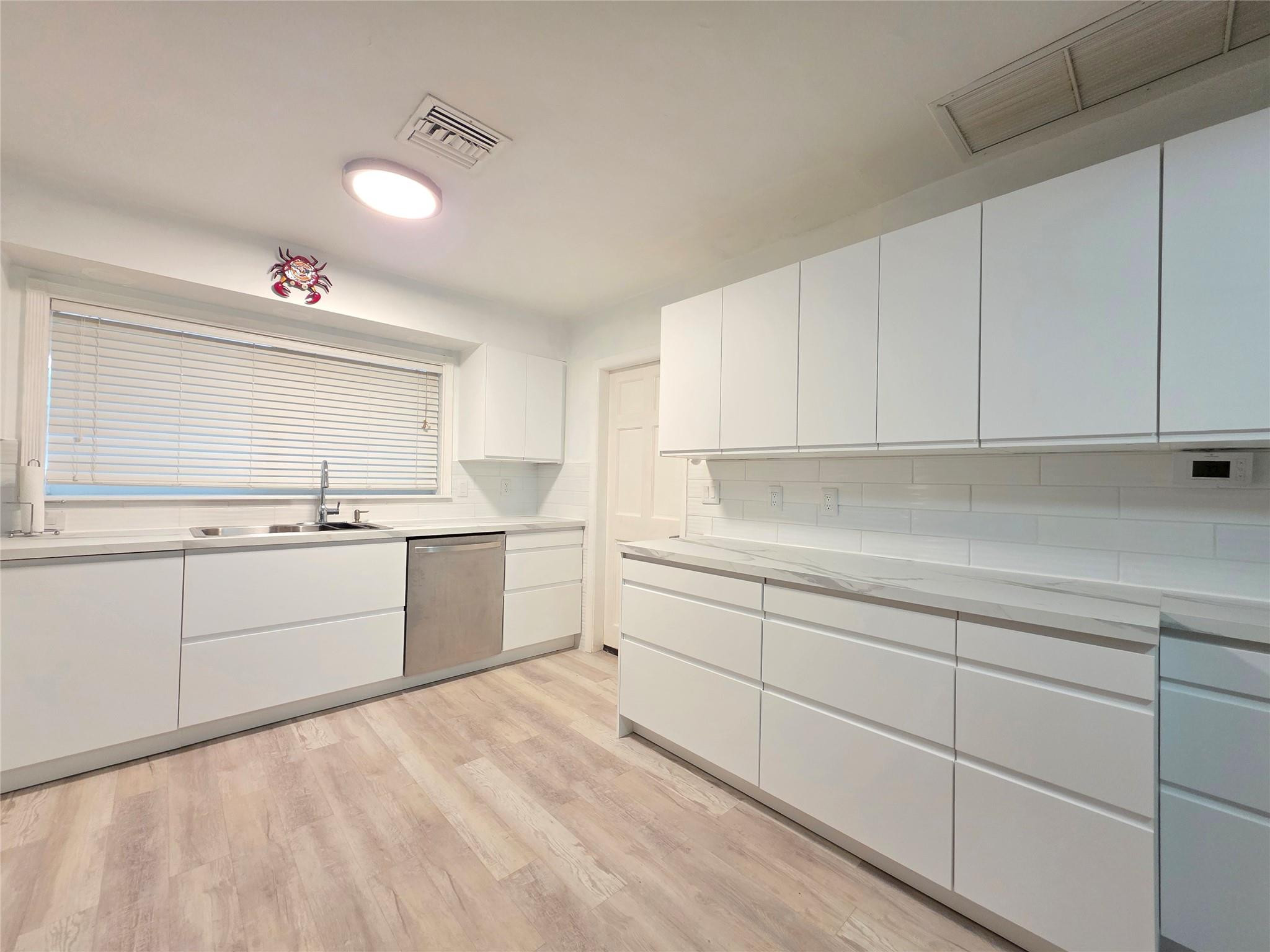 2585 Southeast 3rd Street Pompano Beach, FL 33062 - Photo 14 of 71 a kitchen with sink cabinets and window