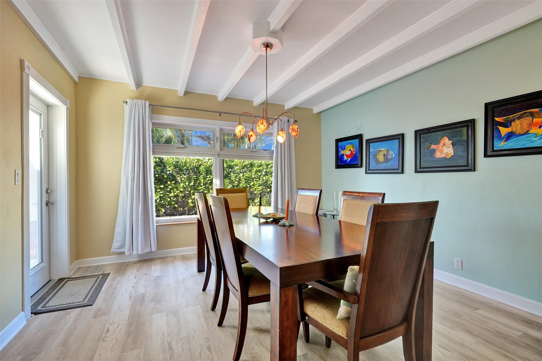 2585 Southeast 3rd Street Pompano Beach, FL 33062 - Photo 21 of 71 a dining room with furniture a chandelier and wooden floor