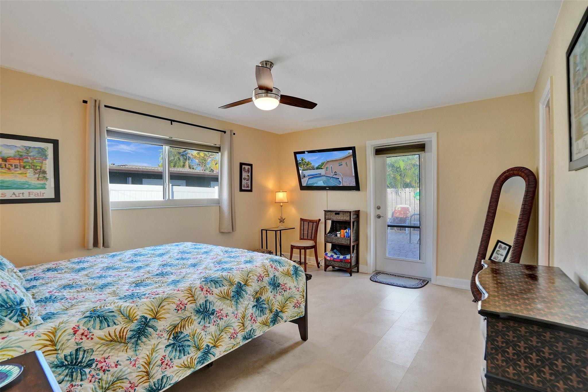 2585 Southeast 3rd Street Pompano Beach, FL 33062 - Photo 23 of 71 a bedroom with a bed and a dresser with mirror