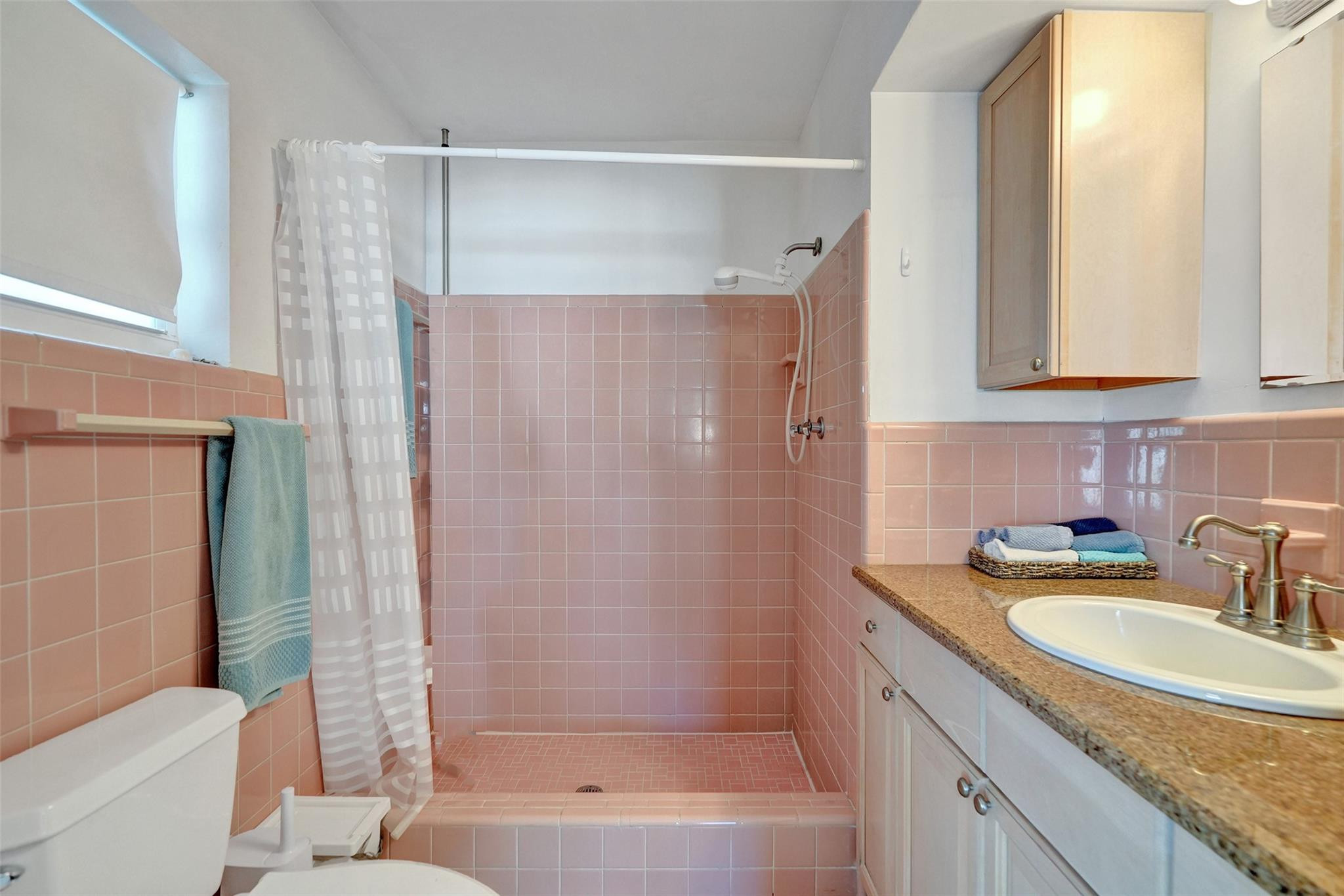 2585 Southeast 3rd Street Pompano Beach, FL 33062 - Photo 26 of 71 a bathroom with a granite countertop sink a mirror a bathtub and shower