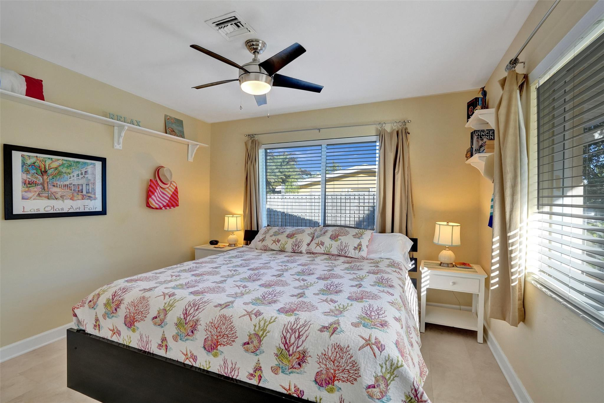 2585 Southeast 3rd Street Pompano Beach, FL 33062 - Photo 29 of 71 a bedroom with a large bed and a chandelier