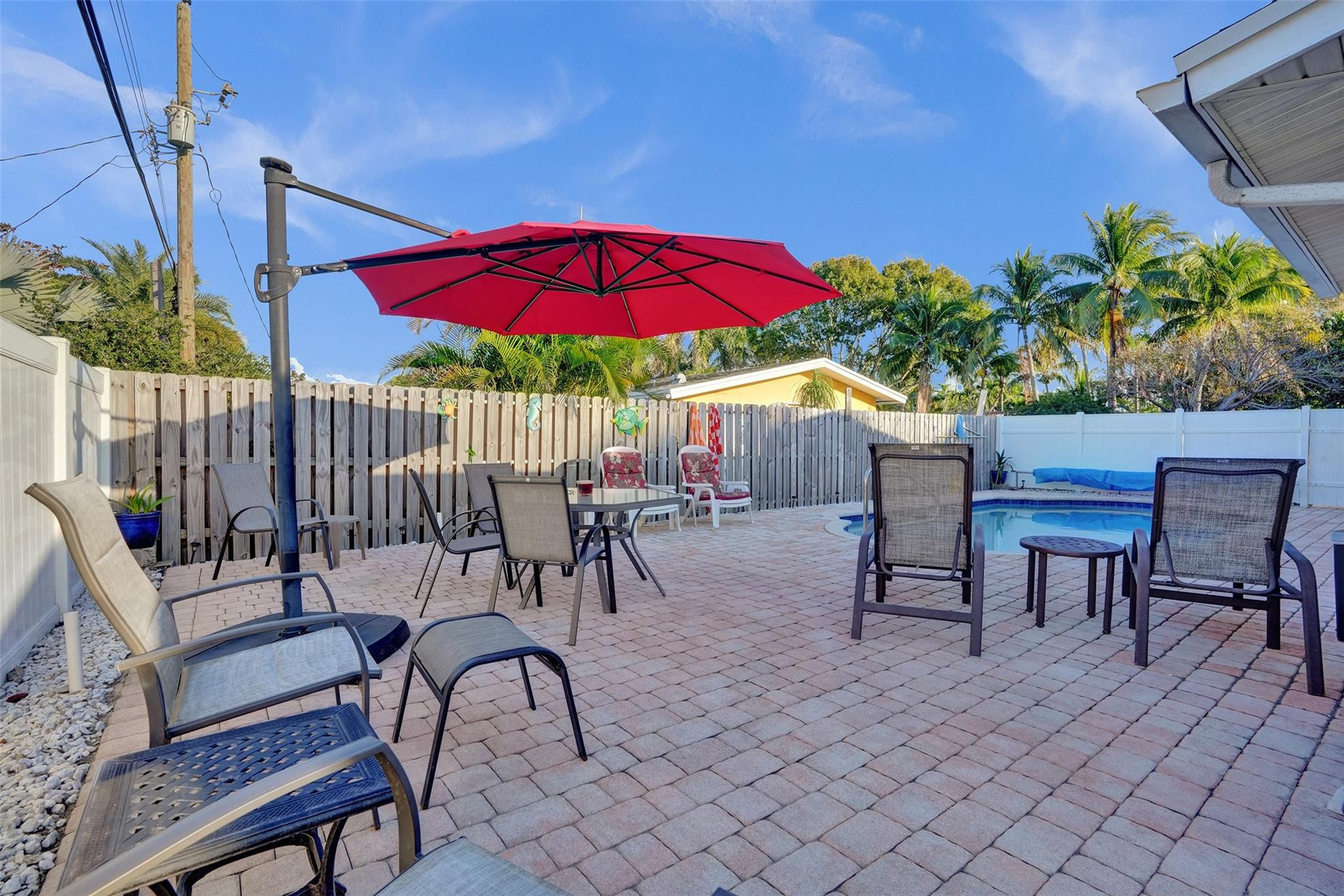 2585 Southeast 3rd Street Pompano Beach, FL 33062 - Photo 45 of 71 a view of a patio with a table and chairs under an umbrella