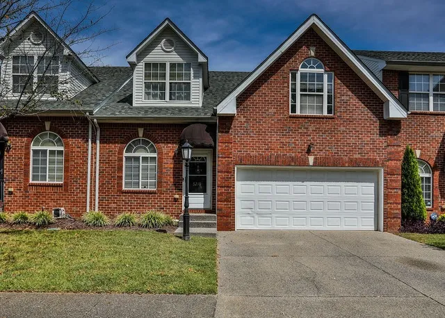 front view of brick house with a yard