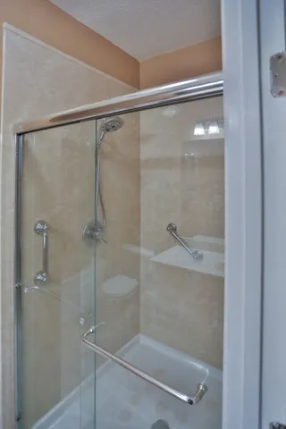a bathroom with a glass shower door