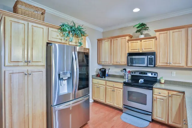 a kitchen with stainless steel appliances a refrigerator sink and cabinets