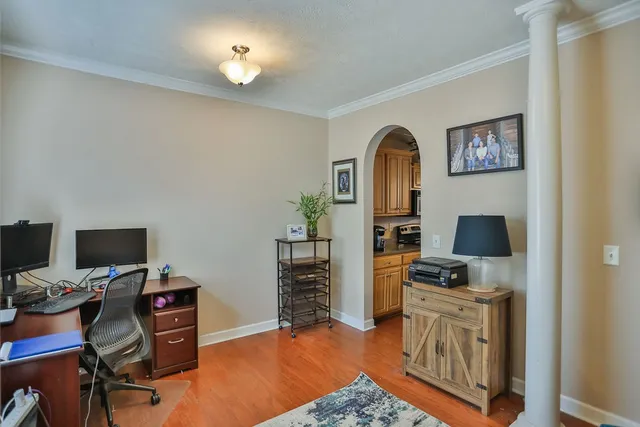 a view of a workspace with furniture and a flat screen tv